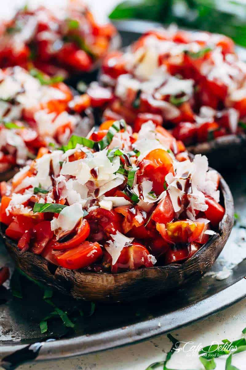 Grilled Bruschetta Portobello Mushrooms smothered in garlic butter are your new favourite way to eat a mushroom! Breakfast, Lunch OR dinner! | https://cafedelites.com