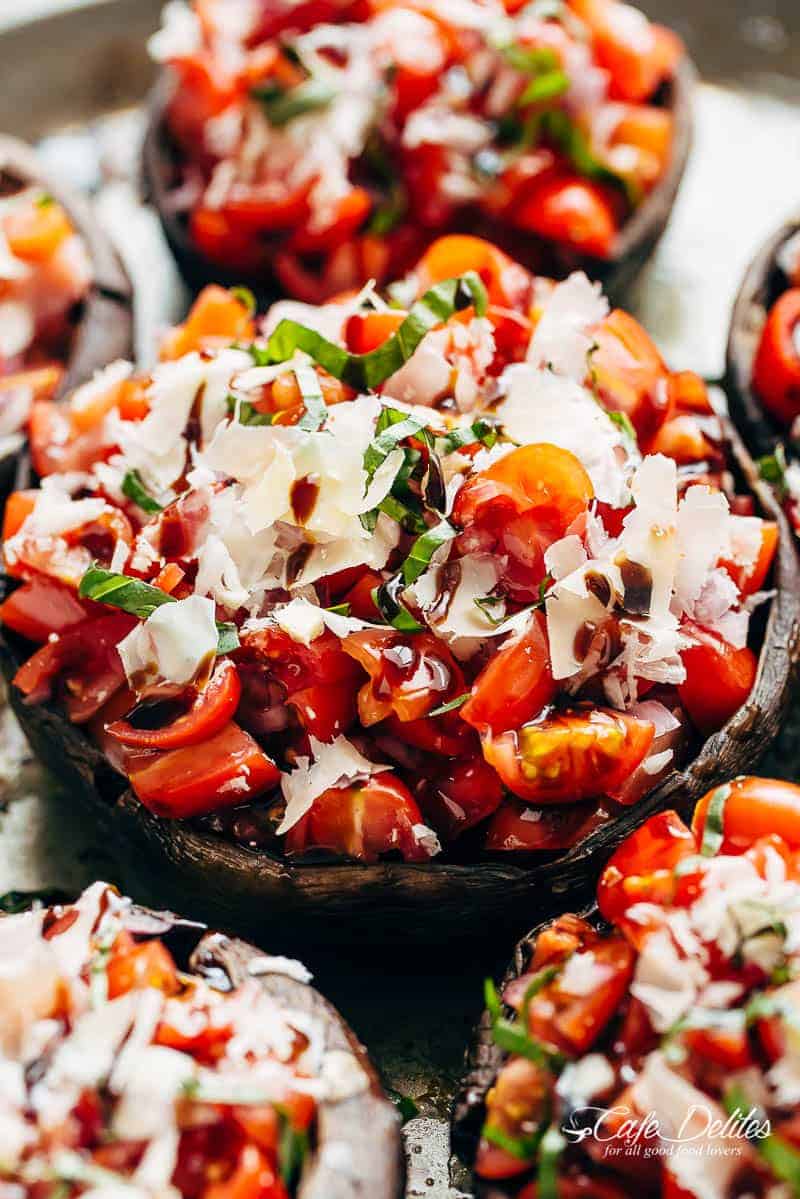 Grilled Bruschetta Portobello Mushrooms smothered in garlic butter are your new favourite way to eat a mushroom! Breakfast, Lunch OR dinner! | https://cafedelites.com