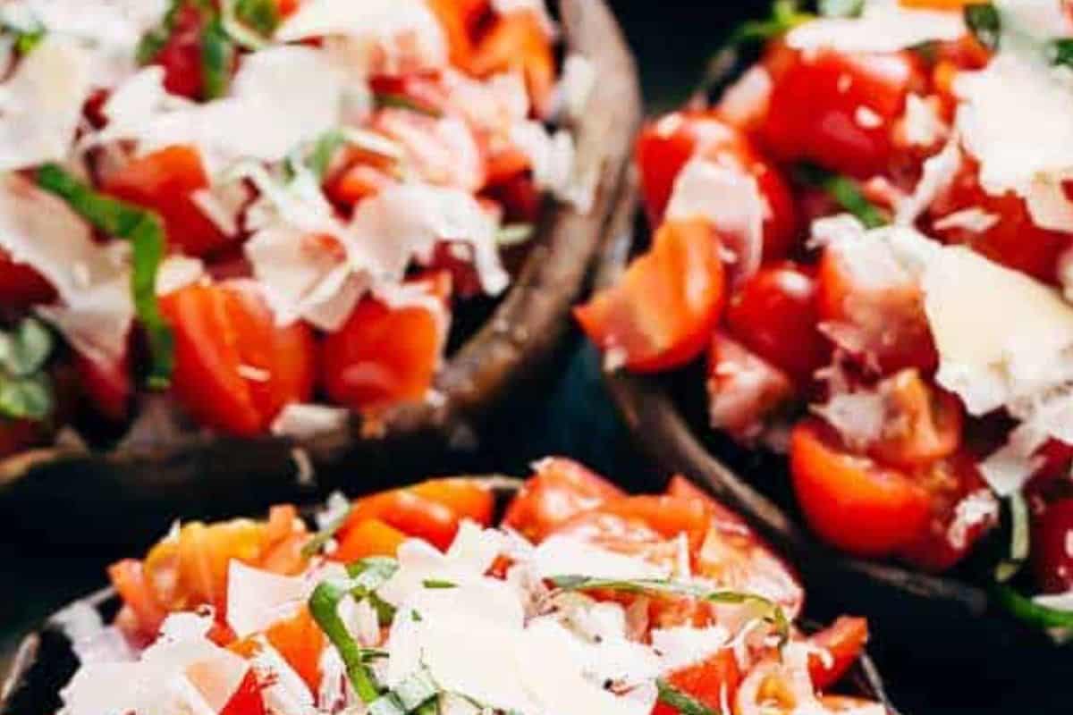 Remove the mushrooms from the grill and spoon the bruschetta mixture over each one