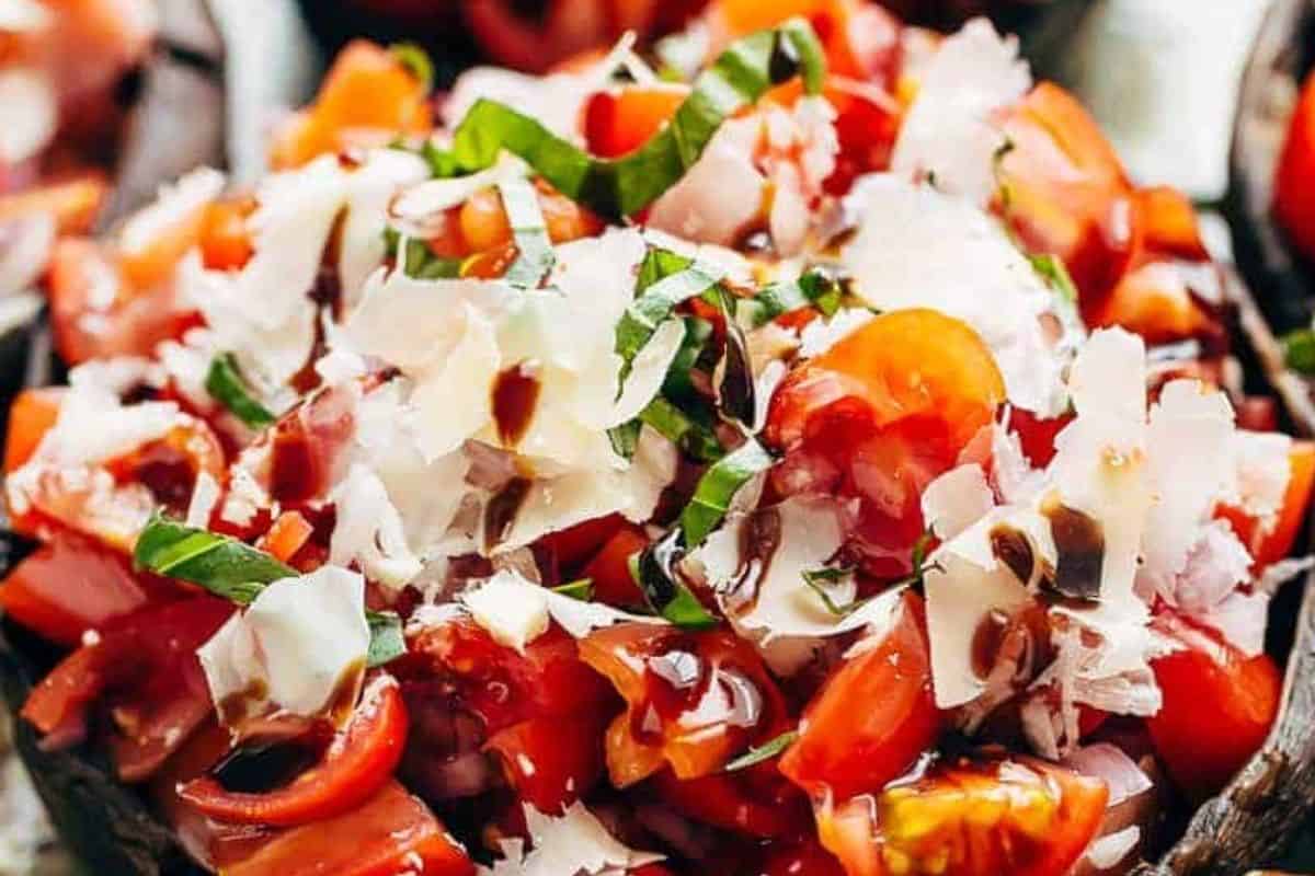 Drizzle with the balsamic glaze, sprinkle with extra salt, and garnish with the remaining basil