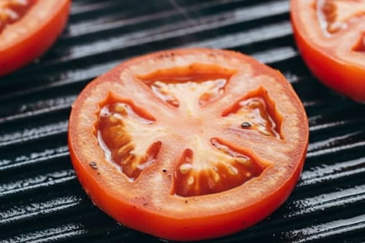 While the chicken cooks, grill the tomato slices for 1 to 2 minutes per side