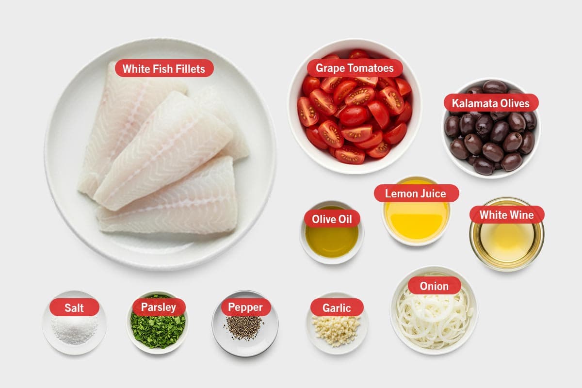 Top shot of ingredients: white fish fillets, grape tomatoes, kalamata olives, olive oil, lemon juice, white wine, salt, parsley, pepper, garlic, and onion.