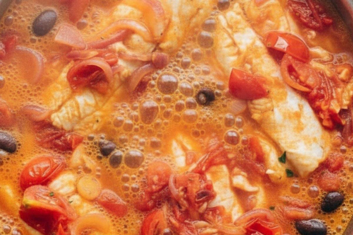 Simmering until the fish is cooked through.