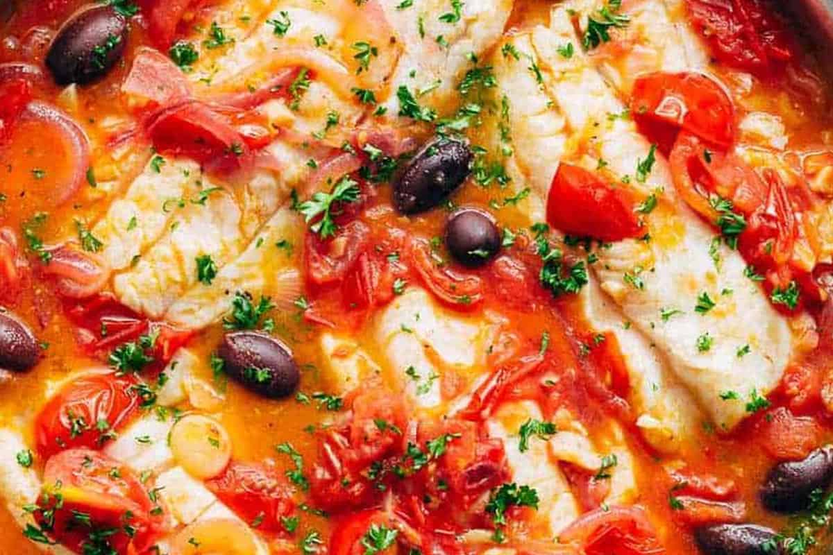 Close-up shot of Pan Seared Fish With Tomatoes & Olives.