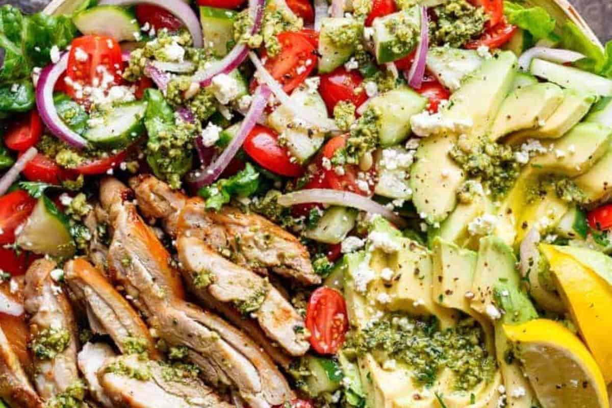 Let the chicken rest for 5 minutes, then slice and arrange it over the salad. Drizzle with the reserved dressing, and garnish.