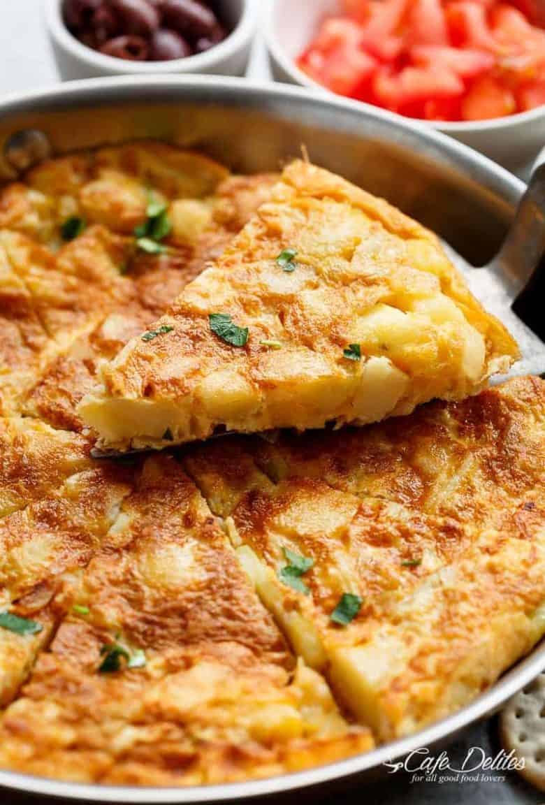 Spanish Omelette (Spanish Tortilla) is perfect served hot or cold, and so easy to make! Crispy, fried potatoes and eggs make up this popular Spanish Tortilla recipe, perfect for picnics, parties, bbq's, or your traditional Tapas menu! Upgrade your omelette! | https://cafedelites.com