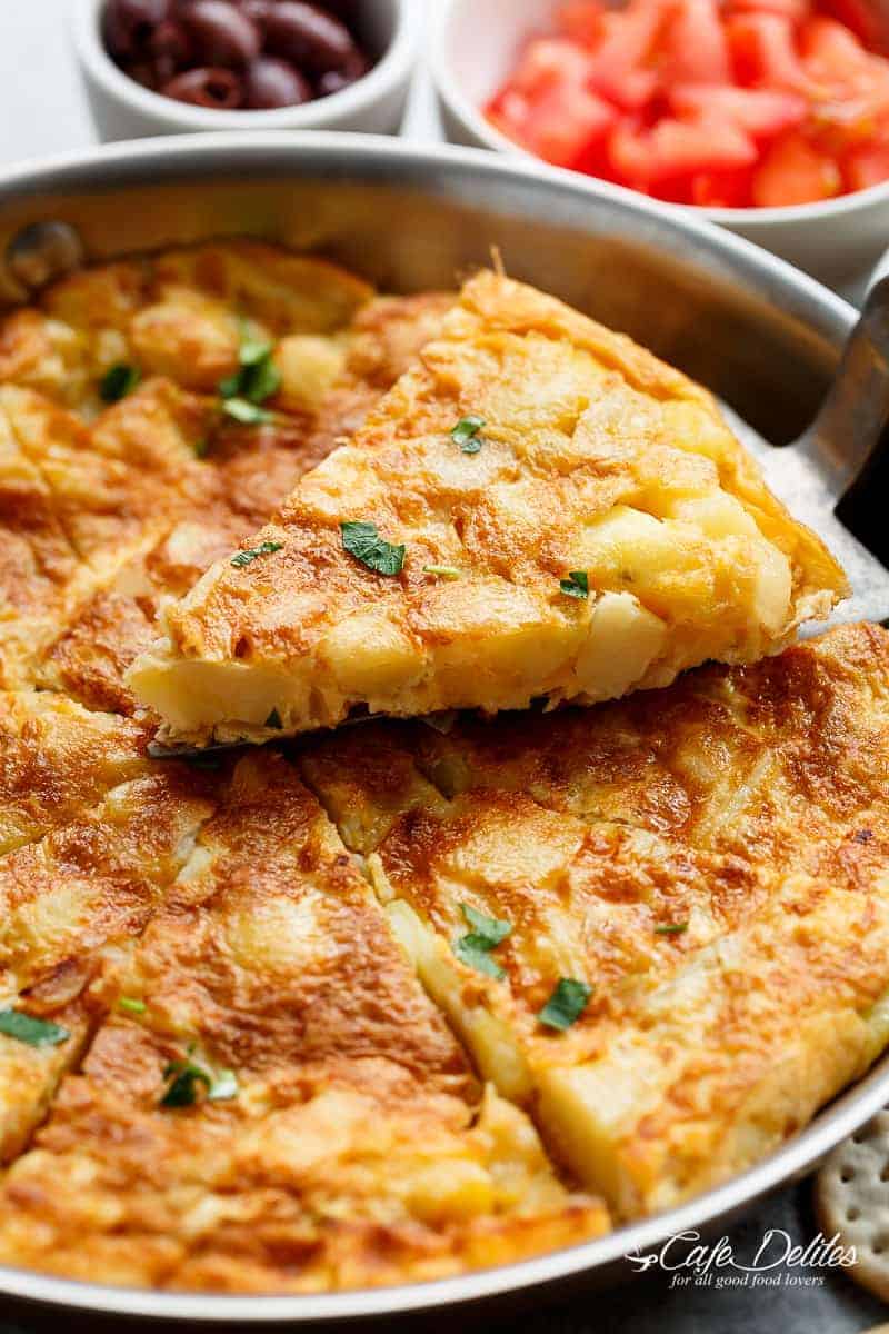 Spanish Omelette (Spanish Tortilla) is perfect served hot or cold, and so easy to make! Crispy, fried potatoes and eggs make up this popular Spanish Tortilla recipe, perfect for picnics, parties, bbq's, or your traditional Tapas menu! Upgrade your omelette! | https://cafedelites.com