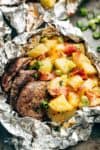 Steak & Cheesy Bacon Potato Hash Foil Packs can be cooked on the grill, stove top OR oven! Two favourites cooked in ONE PACK means NO pans to wash up! | https://cafedelites.com