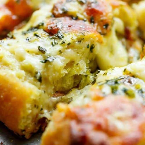 There's regular garlic bread, and then there's THIS Cheesy Garlic Bread! Soft on the inside, crispy on the edges, the perfect cheese/butter/garlic ratio. | https://cafedelites.com