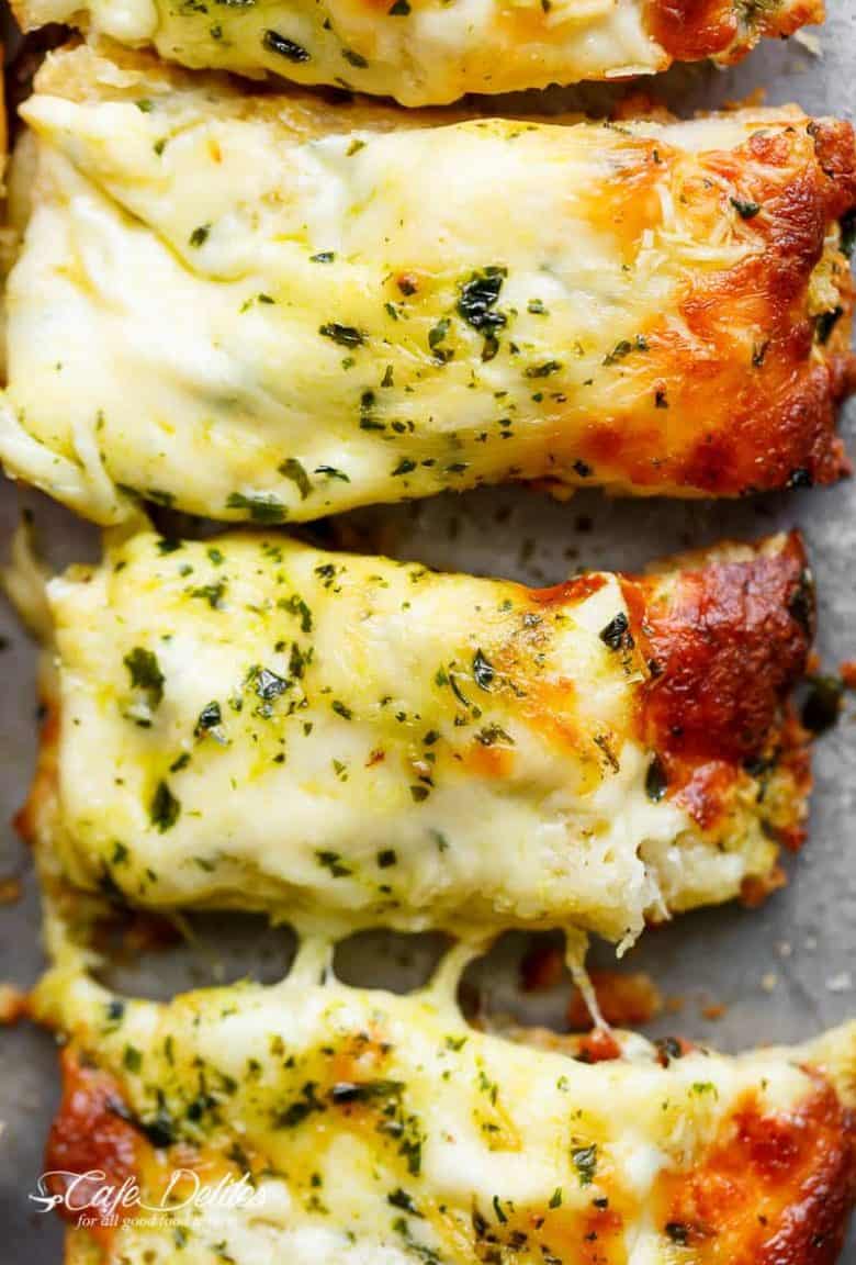 There's regular garlic bread, and then there's THIS Cheesy Garlic Bread! Soft on the inside, crispy on the edges, the perfect cheese/butter/garlic ratio. | https://cafedelites.com