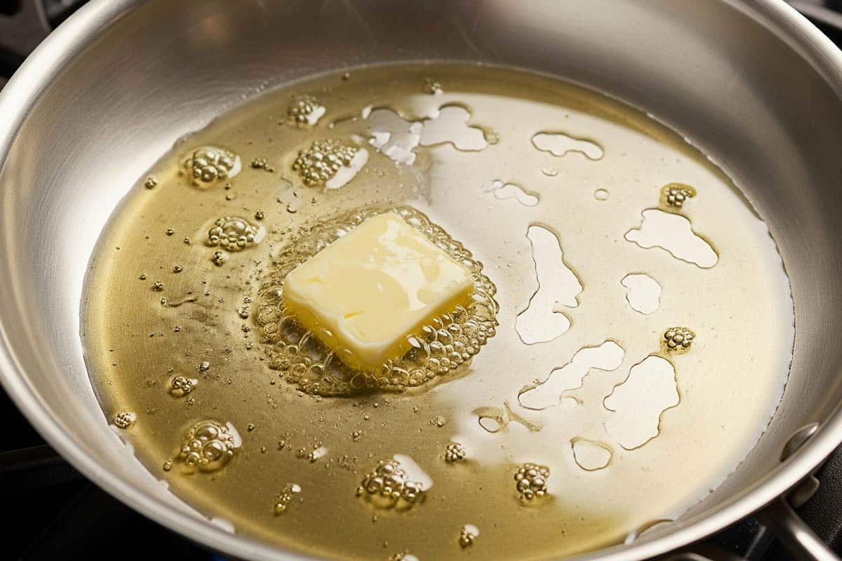 Heating the butter and olive oil in a large skillet.