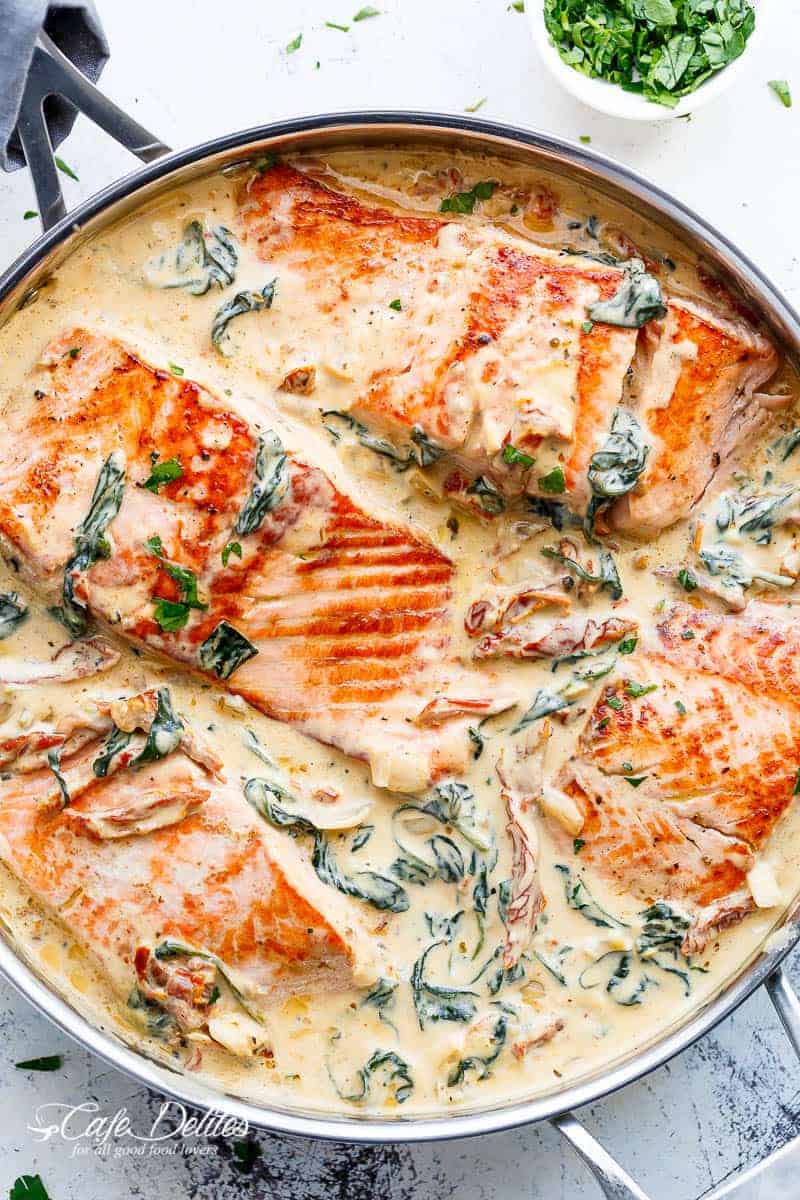 Creamy Garlic Butter Tuscan Salmon (OR TROUT) is such an incredible recipe! Restaurant quality salmon in a beautiful creamy Tuscan sauce! | https://cafedelites.com