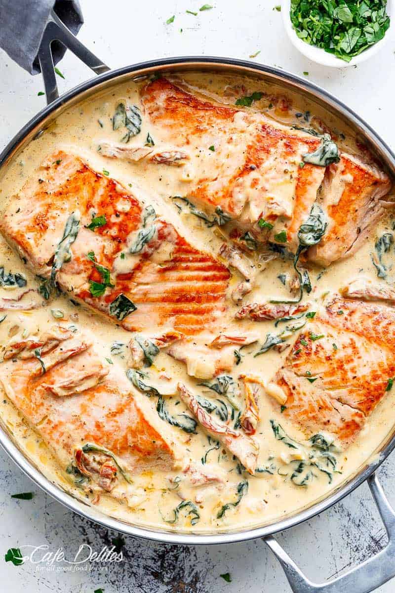 Creamy Garlic Butter Tuscan Salmon (OR TROUT) is such an incredible recipe! Restaurant quality salmon in a beautiful creamy Tuscan sauce! | https://cafedelites.com