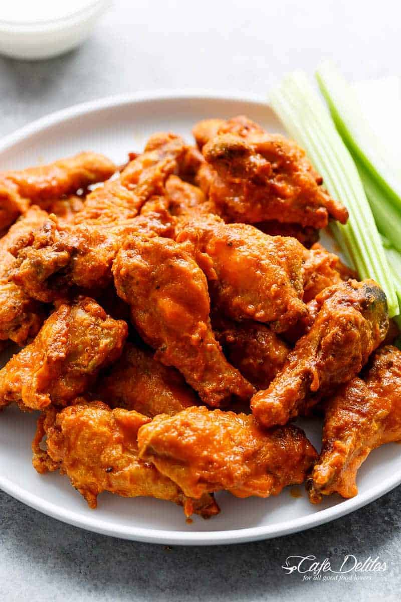 Crispy Buffalo Chicken Wings are exactly what they claim to be. CRISPY without deep frying, using one special ingredient you have in your kitchen pantry! | https://cafedelites.com