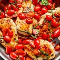 Grape tomatoes burst and cook through a buttery garlic sauce in the Garlic Tomato Basil Chicken recipe! Dinner on the table in minutes! | https://cafedelites./com