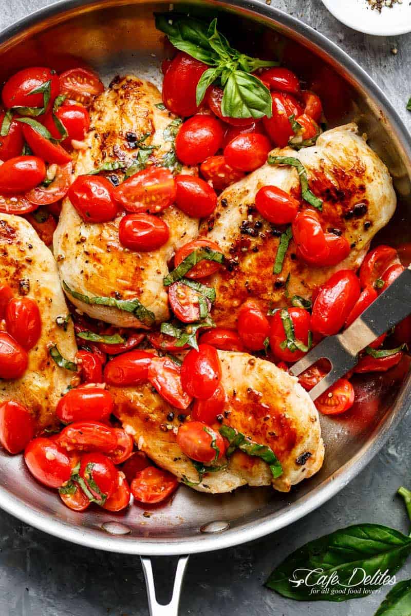 Grape tomatoes burst and cook through a buttery garlic sauce in the Garlic Tomato Basil Chicken recipe! Dinner on the table in minutes! | https://cafedelites./com