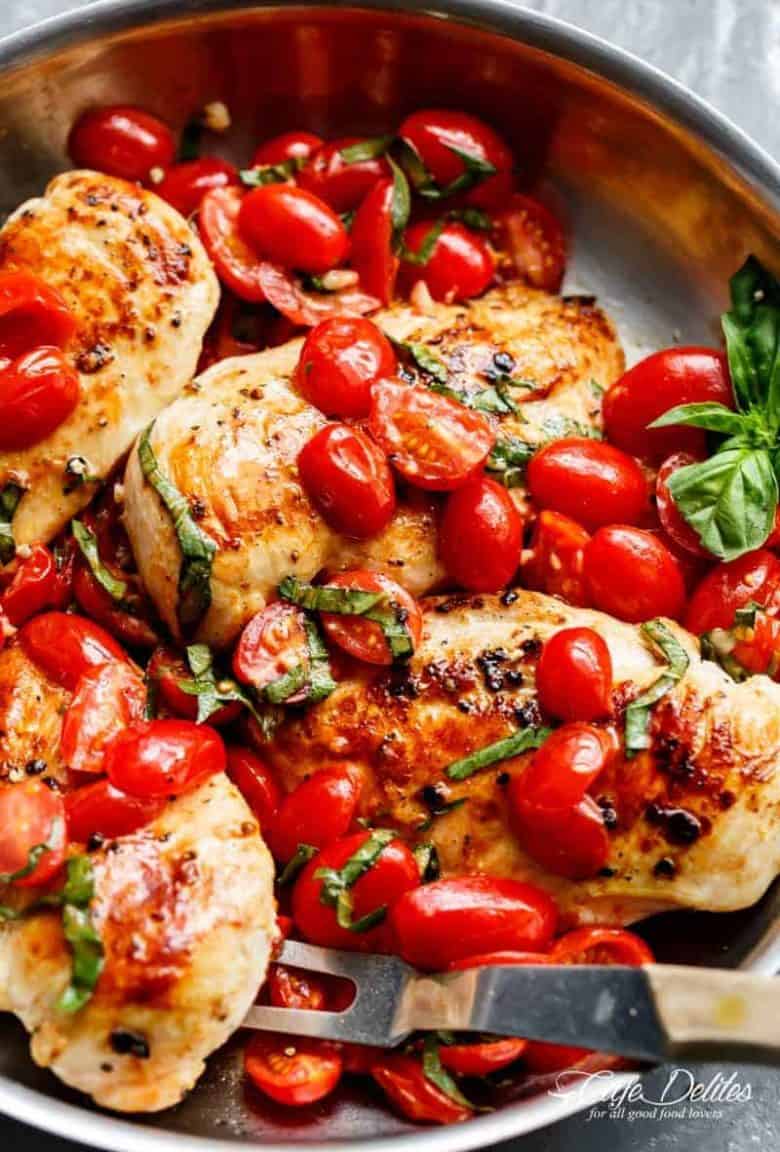 Grape tomatoes burst and cook through a buttery garlic sauce in the Garlic Tomato Basil Chicken recipe! Dinner on the table in minutes! | https://cafedelites./com