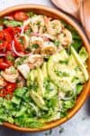 Shrimp Guacamole Salad is a guacamole in a salad bowl! Pan fried shrimp in lemon and garlic flavours are mixed through guacamole ingredients!| https://cafedelites.com