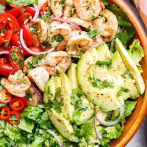 Pan fried shrimp in lemon and garlic flavours are mixed through guacamole ingredients! in a bowl