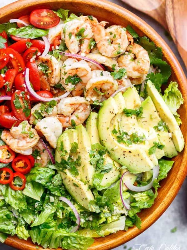 Pan fried shrimp in lemon and garlic flavours are mixed through guacamole ingredients! in a bowl