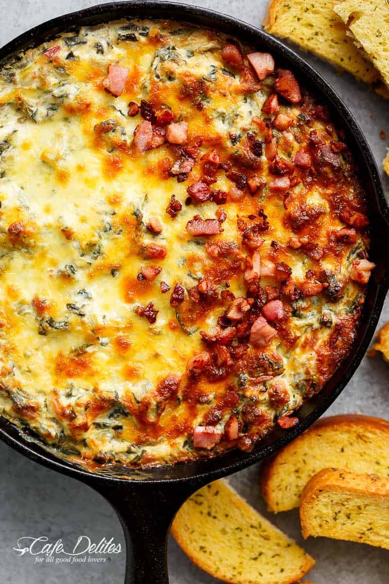 Warm Spinach Bacon Artichoke Dip is a hit around the table! Made with minimal ingredients and topped with crispy bacon, what's not to love! | https://cafedelites.com