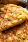 Spanish Omelette (Spanish Tortilla) is perfect served hot or cold, and so easy to make! Crispy, fried potatoes and eggs make up this popular Spanish Tortilla recipe, perfect for picnics, parties, bbq's, or your traditional Tapas menu! Upgrade your omelette! | https://cafedelites.com