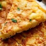 Spanish Omelette (Spanish Tortilla) is perfect served hot or cold, and so easy to make! Crispy, fried potatoes and eggs make up this popular Spanish Tortilla recipe, perfect for picnics, parties, bbq's, or your traditional Tapas menu! Upgrade your omelette! | https://cafedelites.com