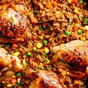 One Pan Asian Chicken and Rice equals crispy skinned chicken full of incredible Chinese-inspired flavours sits on top of a fried rice inspired skillet!