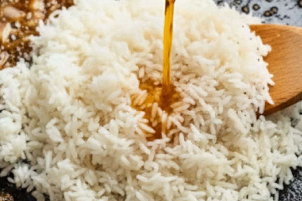Stir the uncooked rice into the pan so it coats in the flavors. Pour in broth, water, oyster sauce, hoisin, and Chinese five spice.
