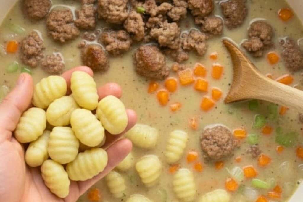 Drop in the fresh gnocchi, give it a quick stir, and cover again. Let it cook for about 30 minutes. - 6