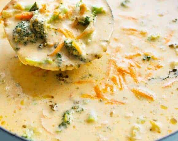 Spoon carrying on Easy Broccoli Cheddar Soup from the bowl