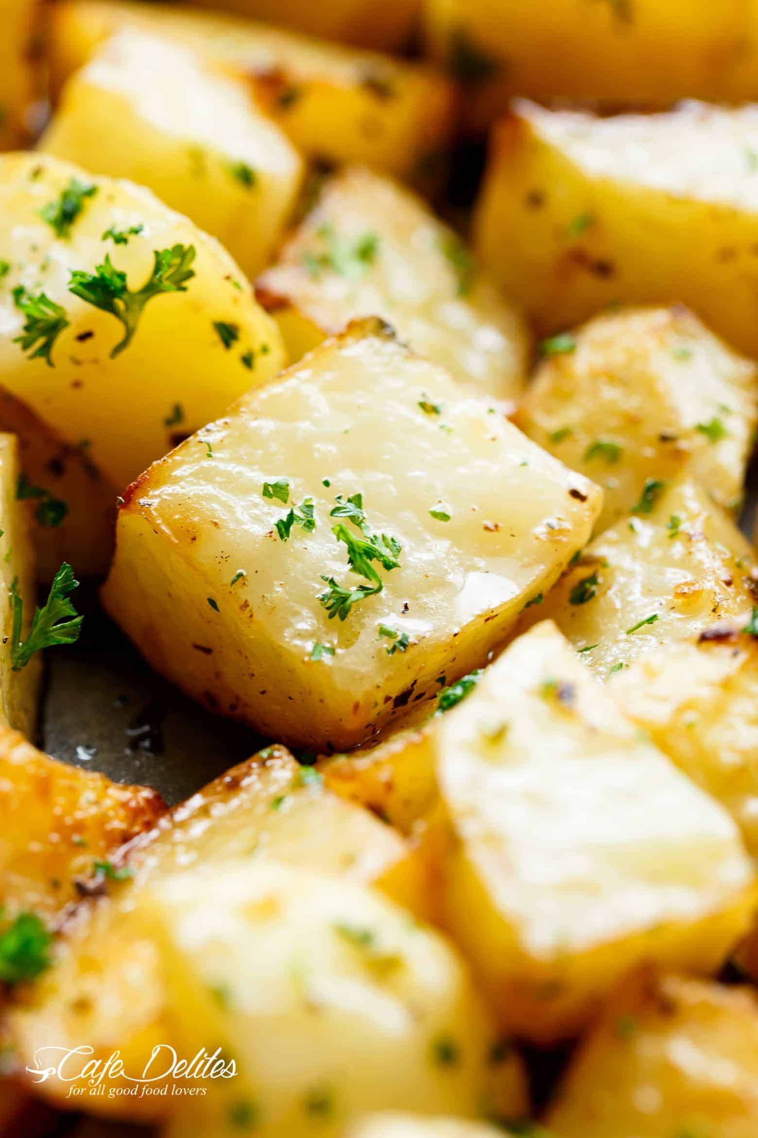 Crispy Garlic Roasted Potatoes are a super simple side dish perfect with anything! Buttery, garlicky, fluffy inside and and crispy edges. These potatoes tick all my boxes! No need for bowls or pans when you can prepare AND cook your potatoes on ONE PAN! | cafedelites.com