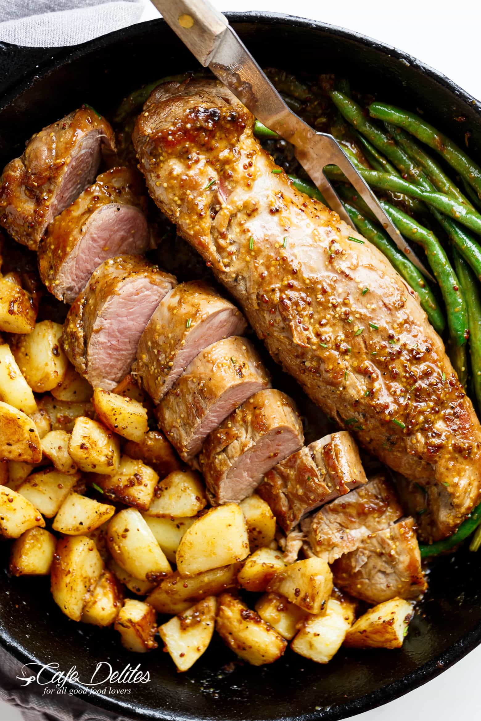 One Pan Dijon Garlic Pork Tenderloin & Veggies is a complete meal with crispy potatoes and tender green beans! All of the flavours cook together! | cafedelites.com