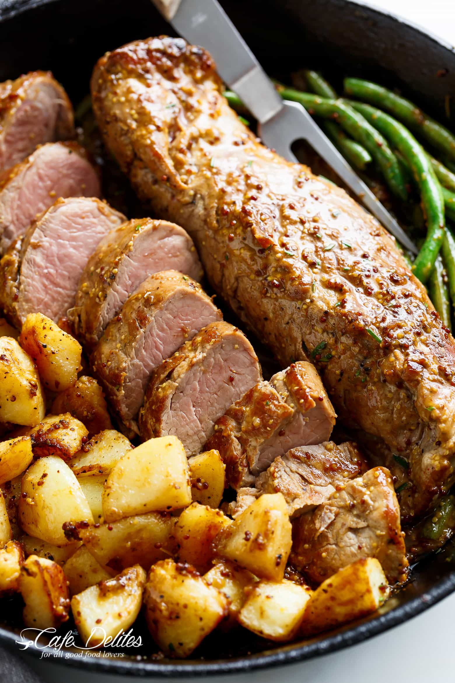 One Pan Dijon Garlic Pork Tenderloin & Veggies is a complete meal with crispy potatoes and tender green beans! All of the flavours cook together! | cafedelites.com