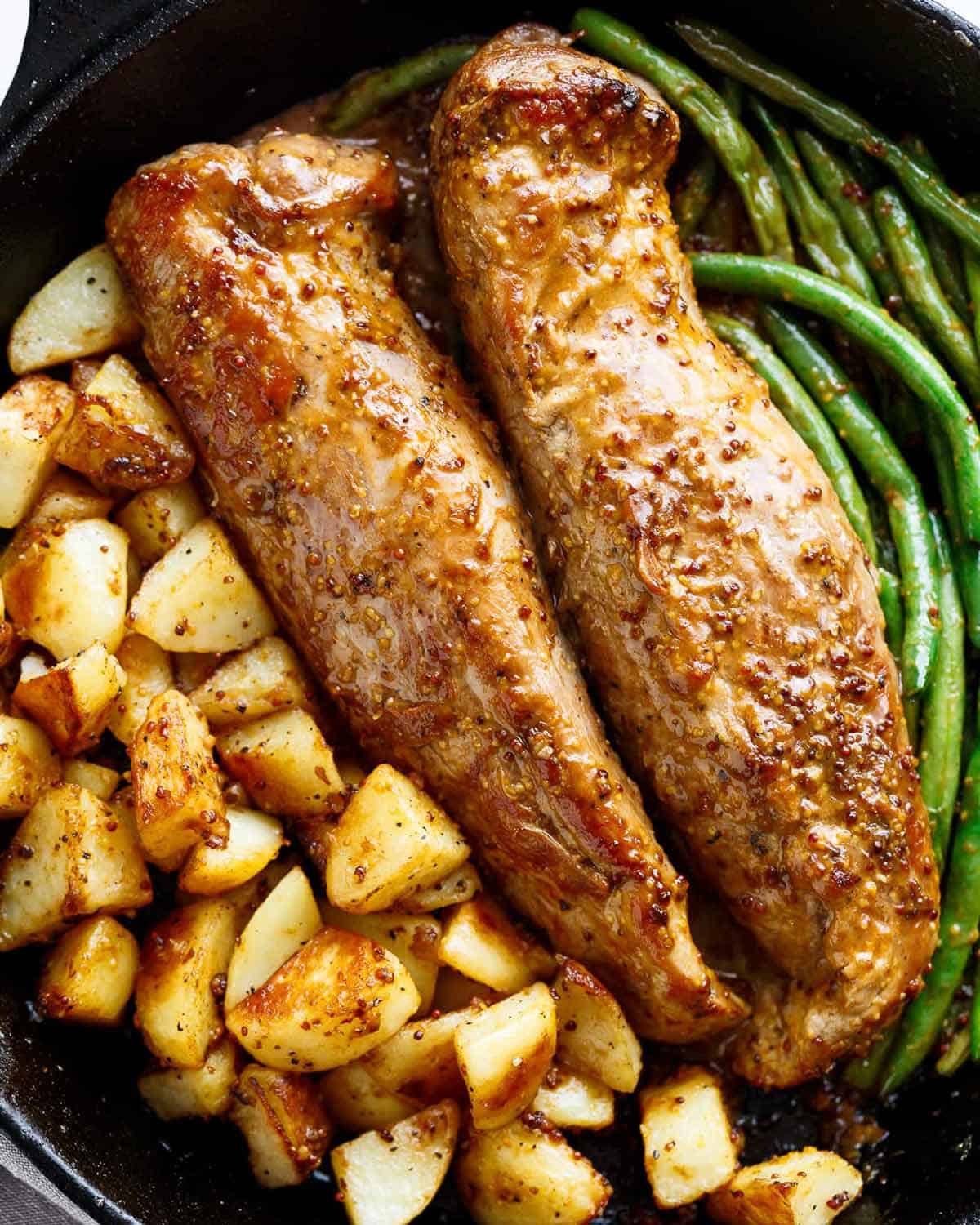 Dijon Garlic Pork Tenderloin slices & fried potatoes on a plate