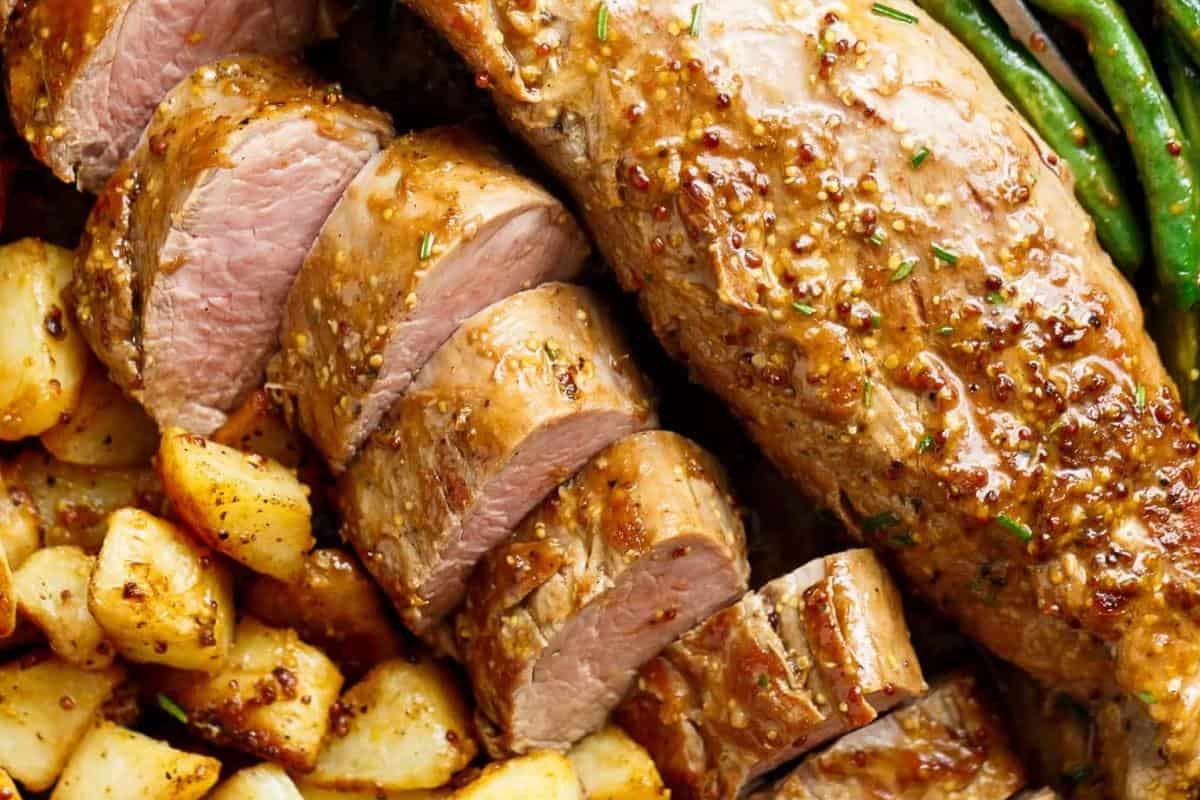 Serve the pork tenderloin with potatoes, green beans, and pan juices.