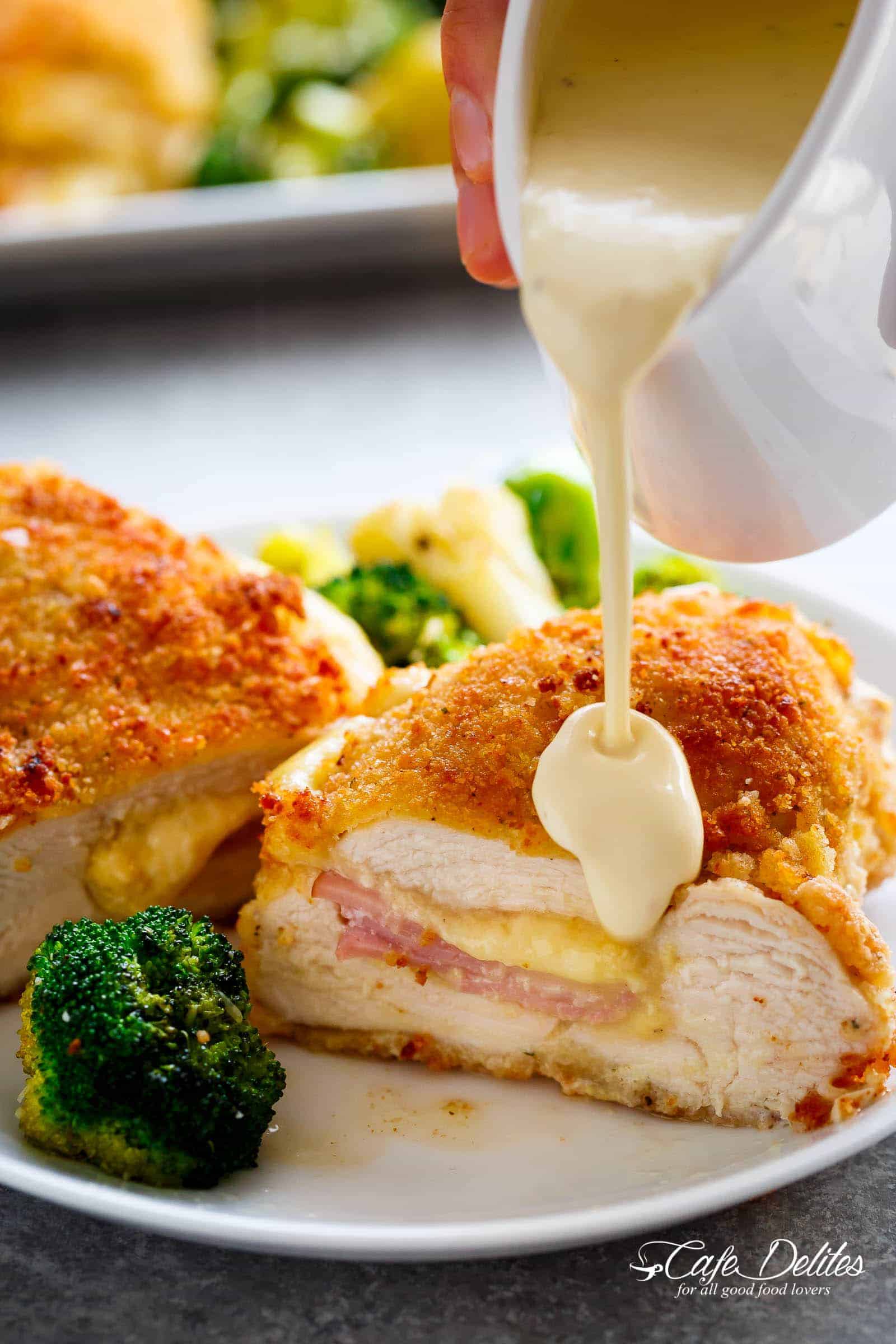 Easy Sheet Pan Chicken Cordon Bleu is a complete dinner for the entire family! Crispy crumbed chicken breasts filled with Dijon mustard, Swiss cheese and ham, baked with vegetables and served with an incredible Dijon Cream Sauce for the ultimate restaurant feel right at home!