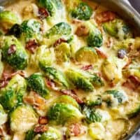 Creamy Garlic Parmesan Brussels Sprouts & Bacon in white pan