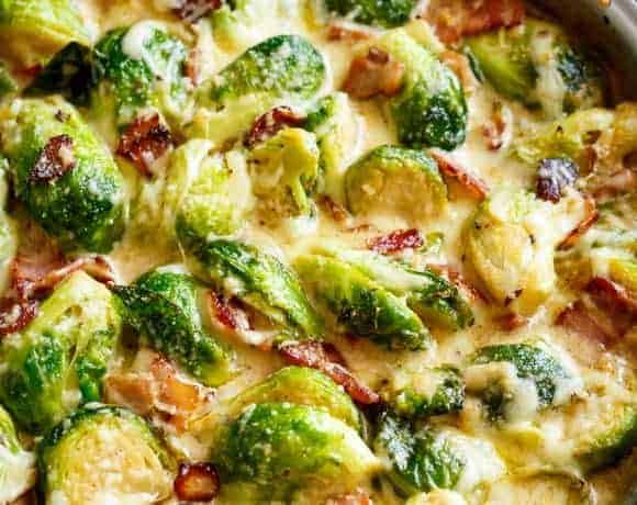 Creamy Garlic Parmesan Brussels Sprouts & Bacon in white pan