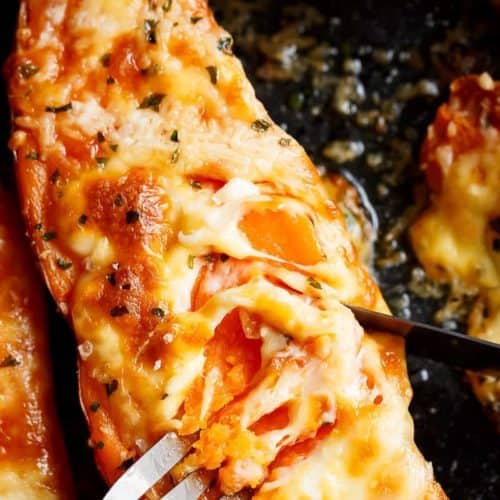 Mozzarella cheese and parmesan top these tender garlic butter smothered sweet potatoes with fork