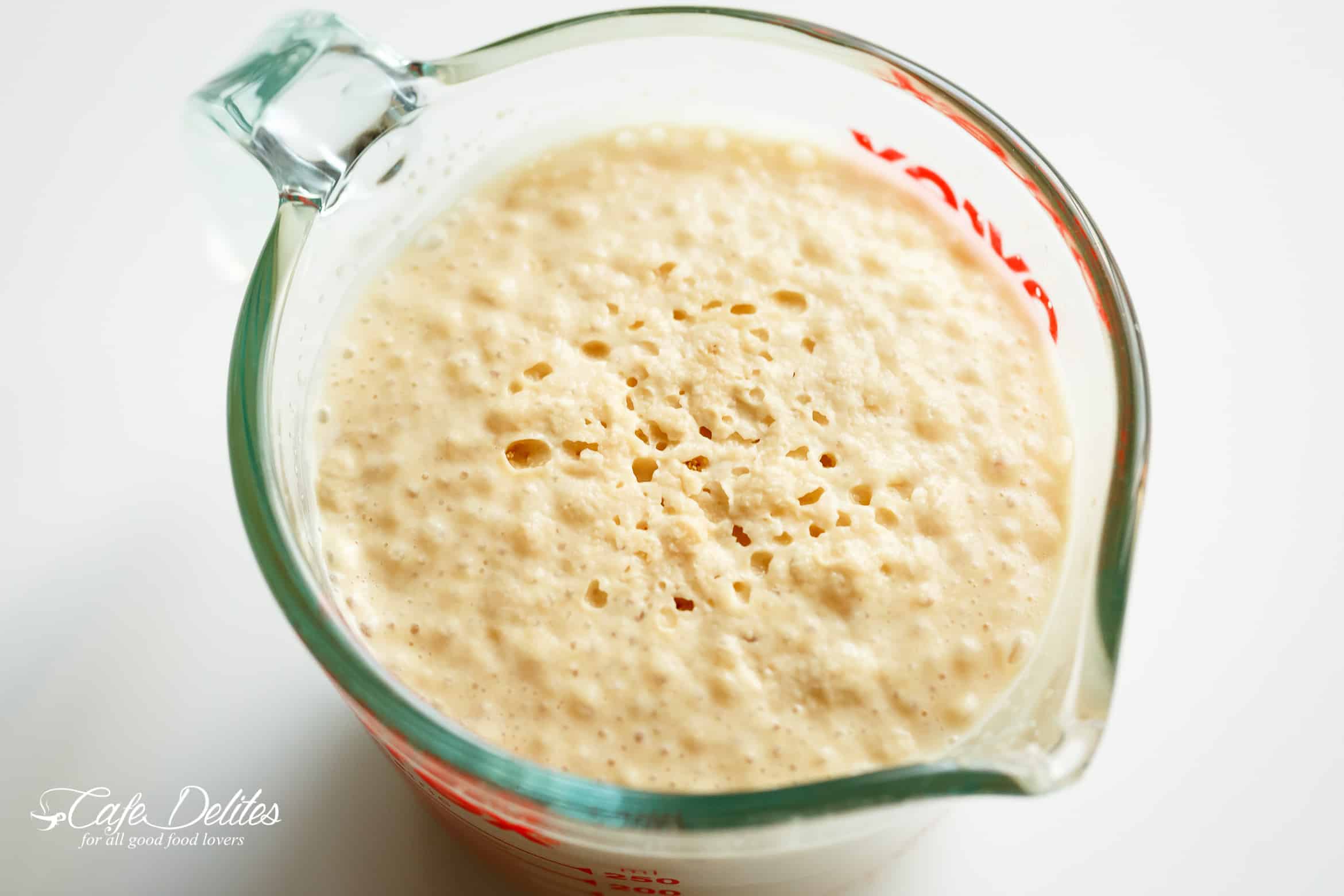 Frothing yeast for soft dinner rolls in a measuring jug. 