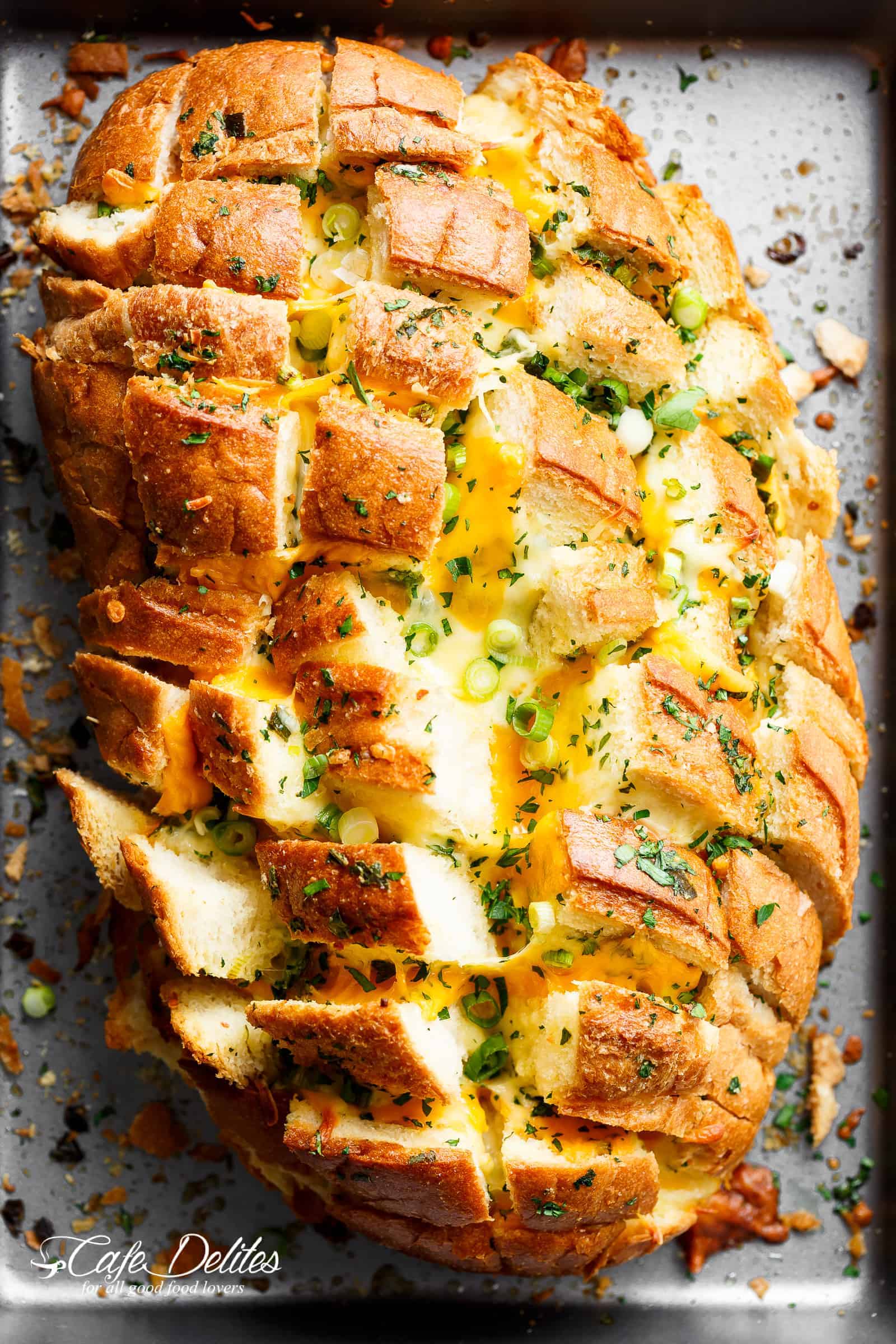 Bloomin' Onion Garlic Bread is ultra cheesy with two types of cheese, garlic butter and green onions baked between wedges of fresh bread! | cafedelites.com
