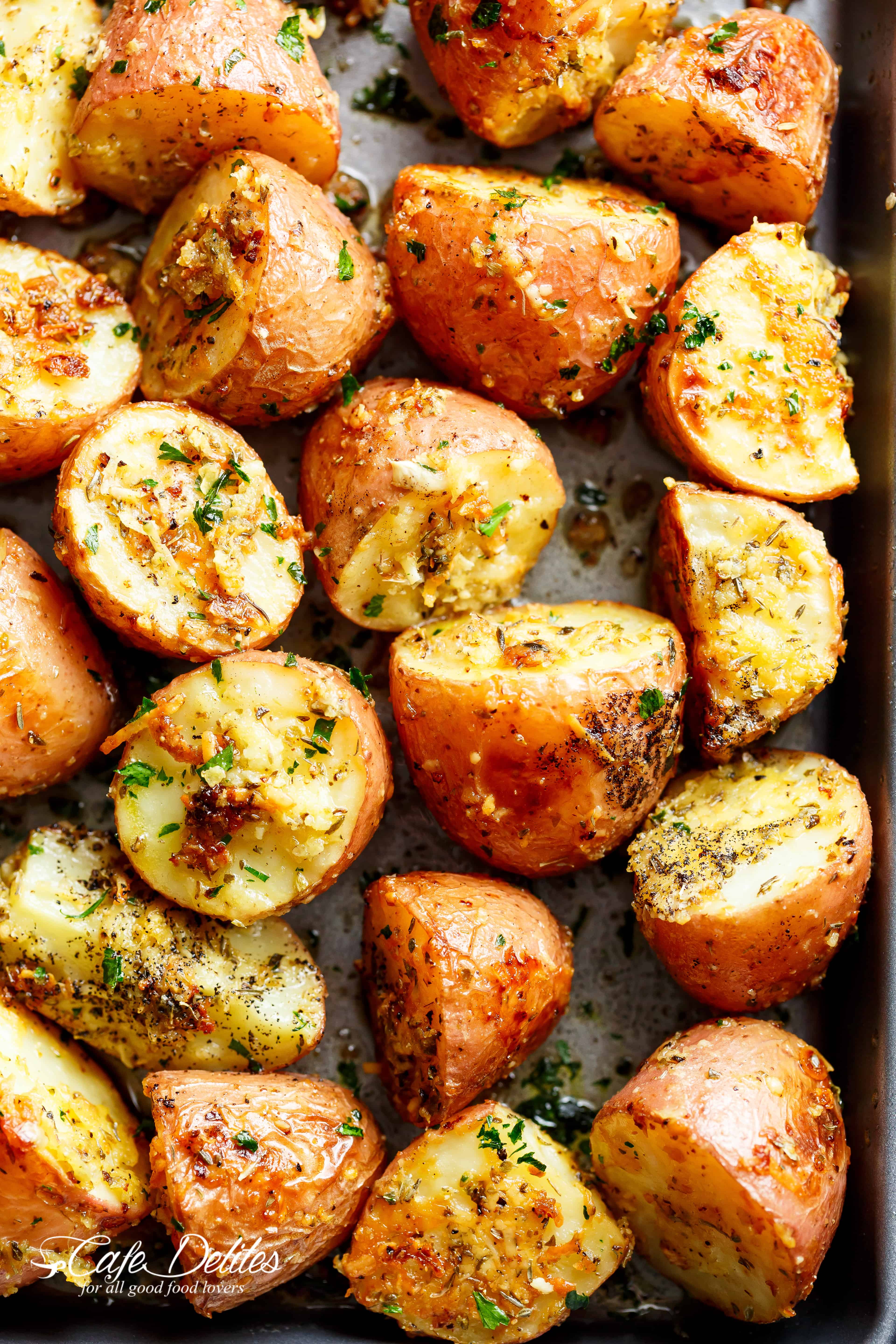 Herbs, garlic, and parmesan cheese are roasted together to make the best Crispy Browned Butter Parmesan Roasted Potatoes! A delicious side dish with so much flavour, these potatoes go with ANYTHING! | cafedelites.com