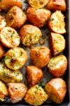 Herbs, garlic, and parmesan cheese are roasted together to make the best Crispy Browned Butter Parmesan Roasted Potatoes! A delicious side dish with so much flavour, these potatoes go with ANYTHING! | cafedelites.com