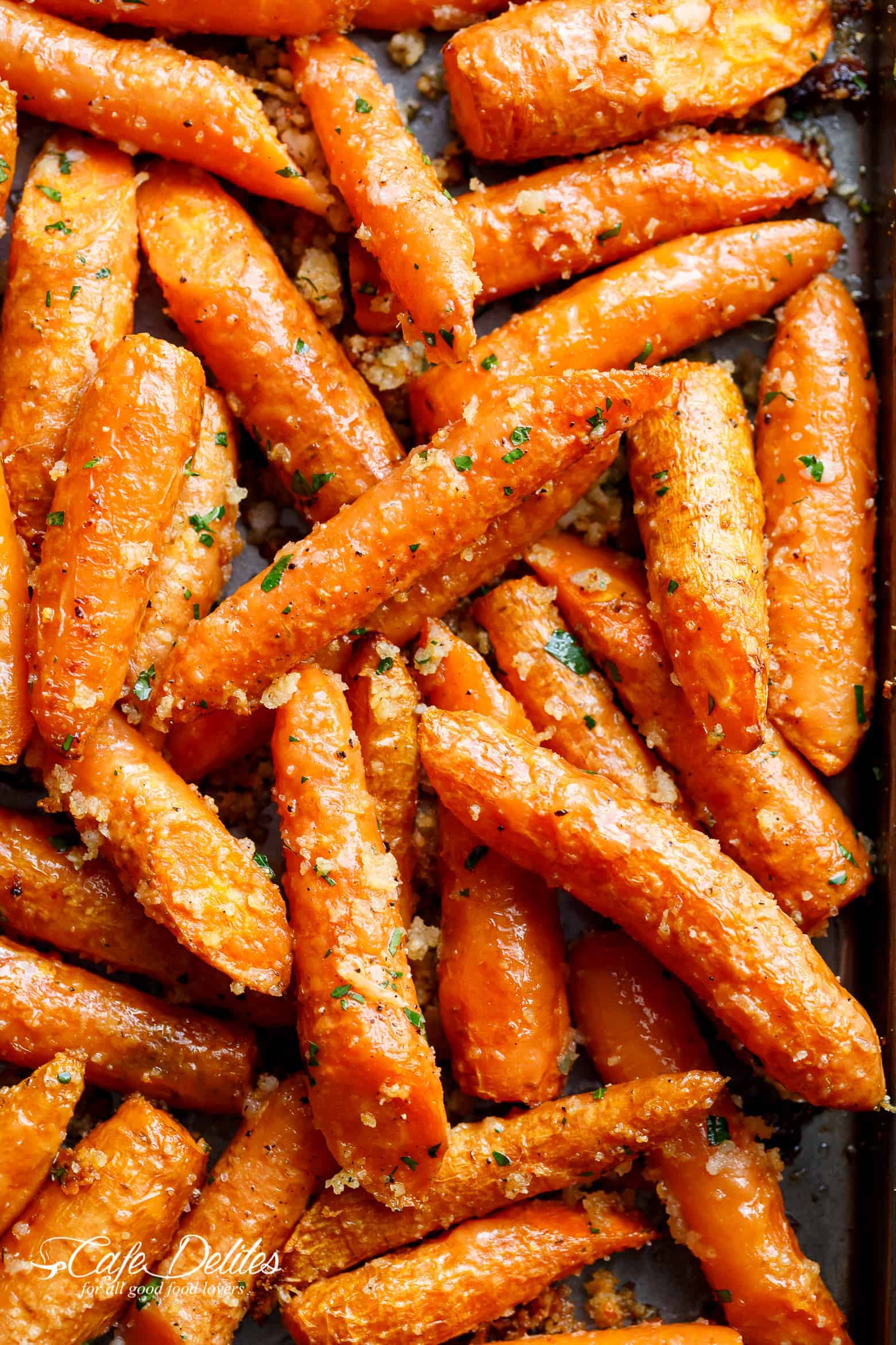 Garlic Parmesan Roasted Carrots are so unbelievably easy to throw together with olive oil, garlic, parmesan cheese and breadcrumbs! | cafedelites.com