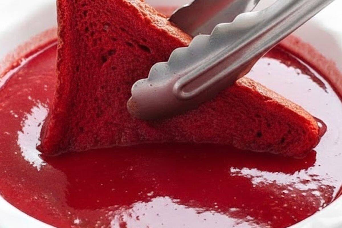 Dip each bread slice into the custard and press gently so it absorbs evenly.