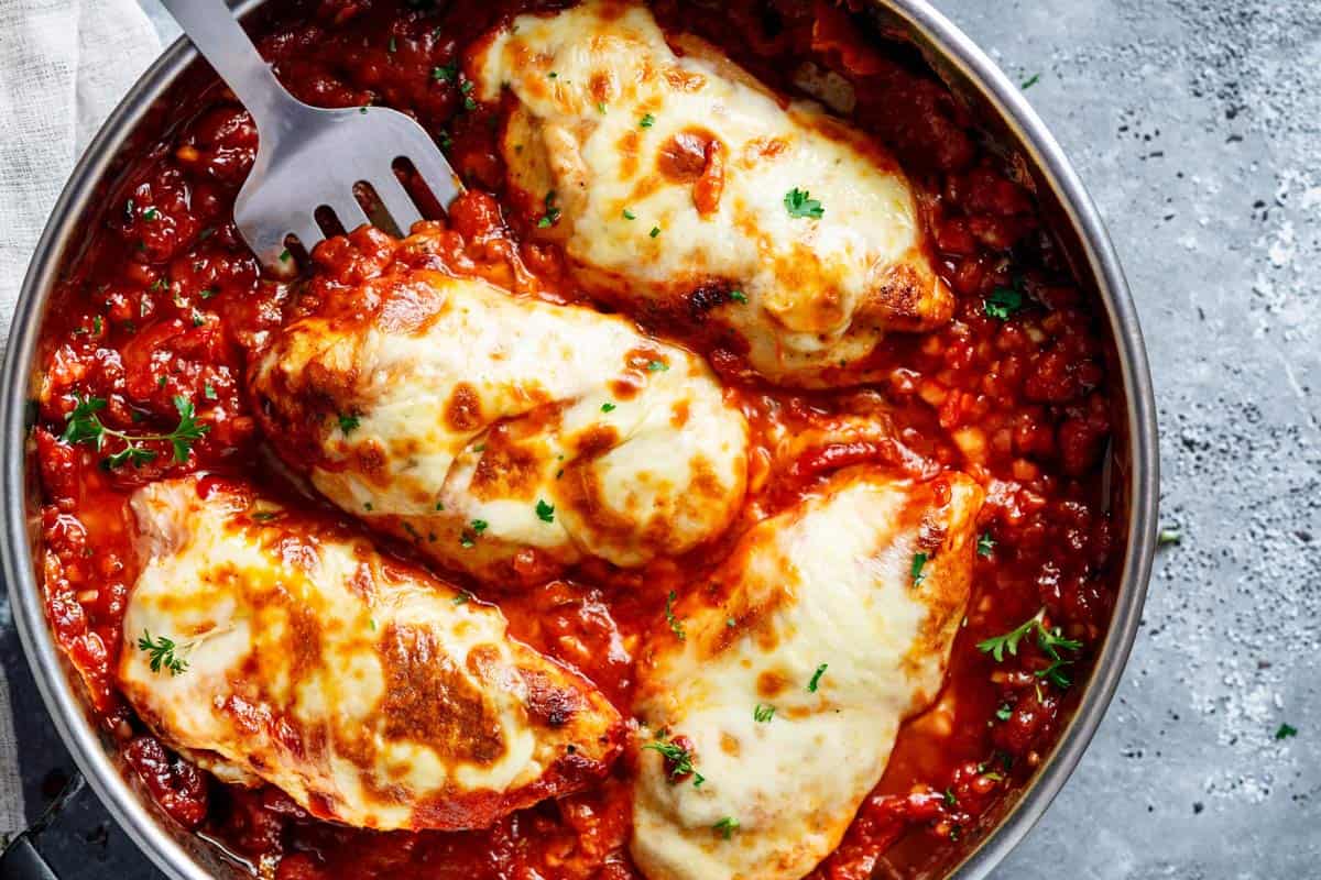 simmering the sauce with the chicken mozarella