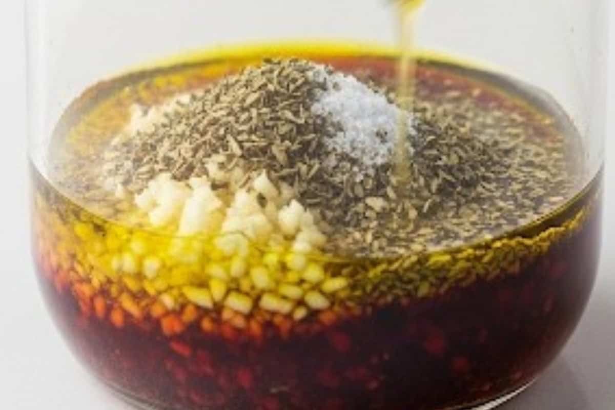 Add olive oil, red wine vinegar, minced garlic, dried oregano and salt.