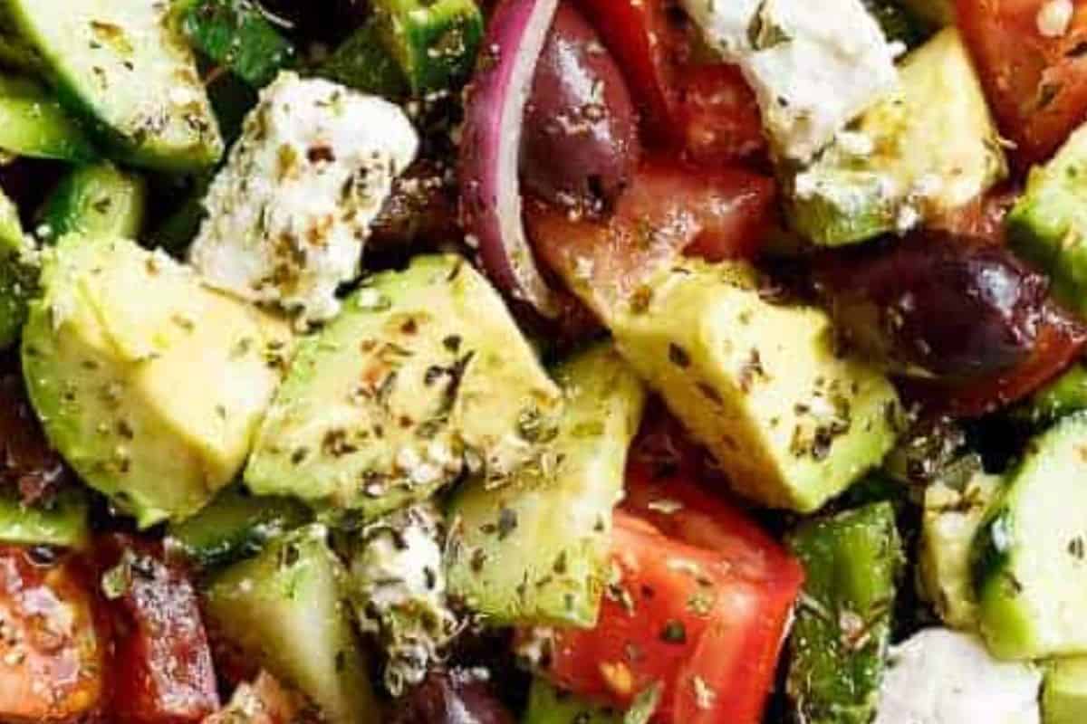 Add all vegetables, feta and olive olives into a large bowl.Pour over the dressing into the greek salad and toss.