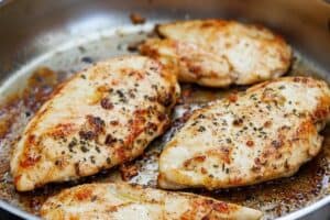 Cooked chicken in a pan after seasoning